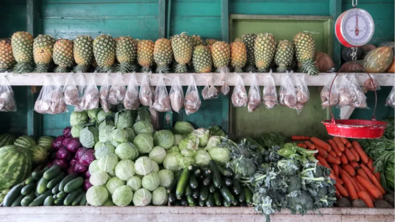 A shelf of tropical fruit and vegetable