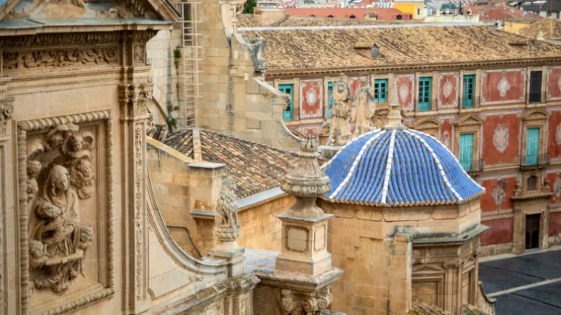 View from behind of the cathedral of Santa Maria in Murcia, Spain, with the episcopal palace in the background and, in the foreground, one of the side facades of the cathedral