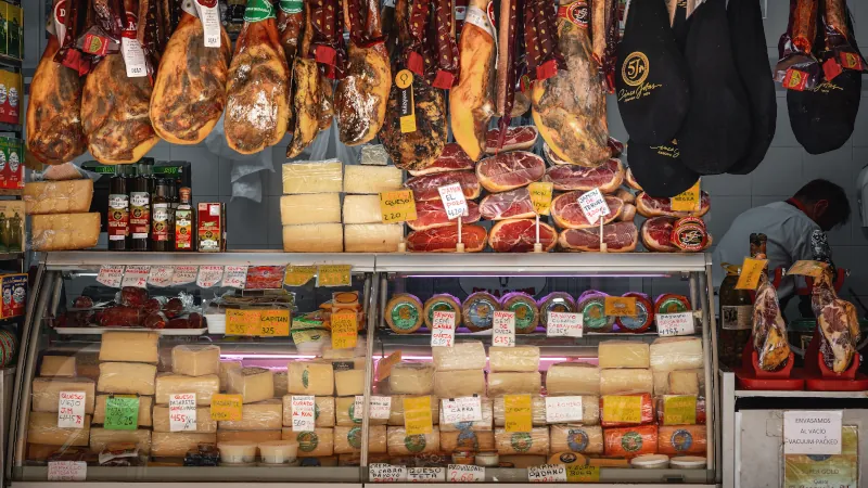 Market Stall with pieces of Jamon iberico (Iberian Ham) and Cheese - Cadiz, Andalusia, Spain