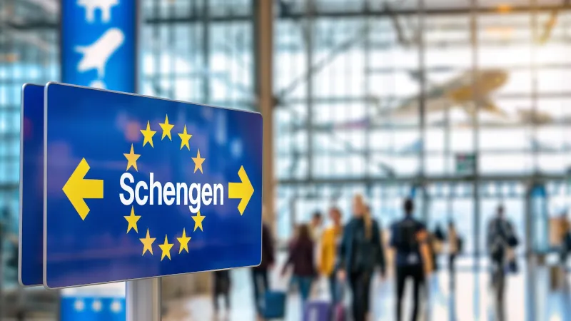 Busy Airport Terminal with Schengen Sign, European Travel Concept with Copy Space