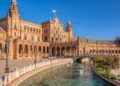 Plaza de España in Seville with canal and historic building under a clear blue sky