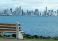 Panama City skyline viewed from waterfront park with bench in foreground