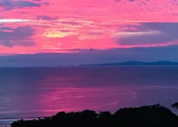 Sunset over the Pacific Ocean from Los Islotes, Azuero Peninsula, Panama, with vivid pink and purple clouds.