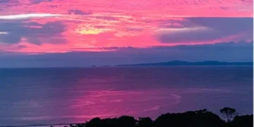 Sunset over the Pacific Ocean from Los Islotes, Azuero Peninsula, Panama, with vivid pink and purple clouds.