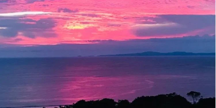 Sunset over the Pacific Ocean from Los Islotes, Azuero Peninsula, Panama, with vivid pink and purple clouds.