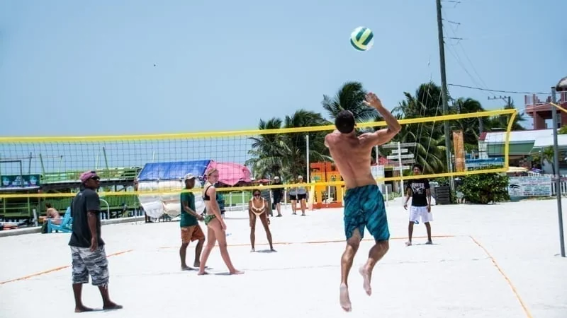 A game of pickup beach volleyball on the island of Caye Caulker. Economy In Belize.