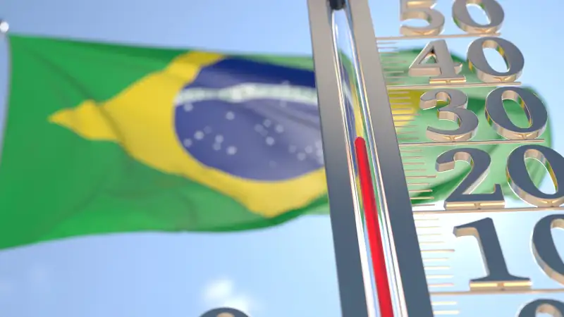 30 degrees centigrade on a thermometer measuring air temperature near flag of Brazil. Hot weather forecast related 3D rendering