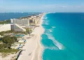 Cancun aerial view. Zona hotelera Cancun beach panorama top view. Caribbean seaside beach with turquoise water and big waves. Yucatan, Quintana Roo, Mexico