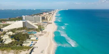 Cancun aerial view. Zona hotelera Cancun beach panorama top view. Caribbean seaside beach with turquoise water and big waves. Yucatan, Quintana Roo, Mexico