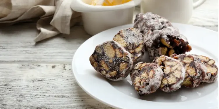 Chocolate salami in a plate over wooden background