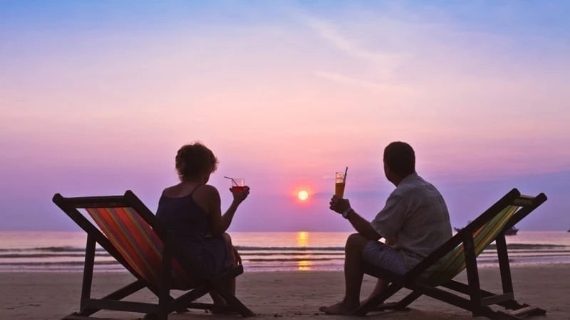 Couple on the beach. taxes in Belize taxes