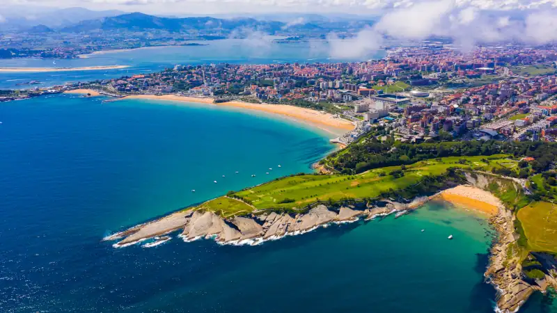 Aerial view of Santander, Spain, showing beaches, rocky coastline, and the cityscape beside the Bay of Biscay.