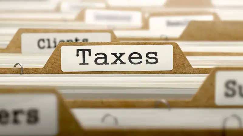 Taxes Concept with Word on Folder.
