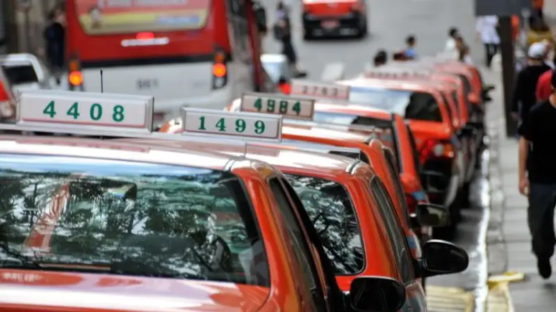 Line of taxi cabs parked by the curb side, downtown, Porto Alegre, Rio Grande do Sul, Brazil