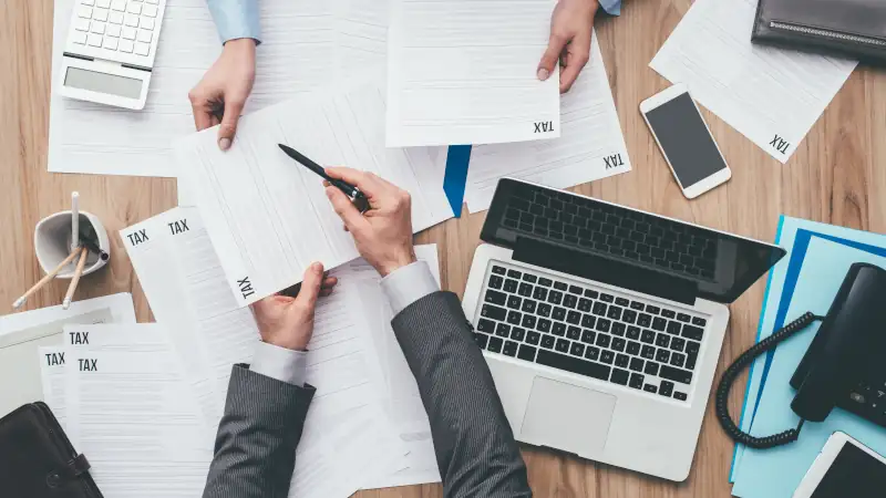 Business people checking tax forms