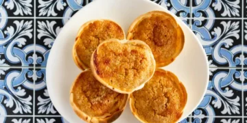 Traditional Portuguese pastry called Queijada de Sintra on portuguese tiles background