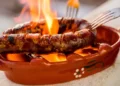 Traditional portuguese chourico or spanish chorizo prepared in a special clay pot