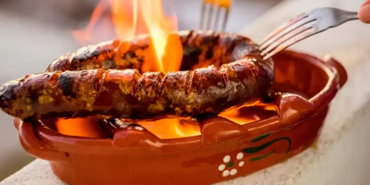 Traditional portuguese chourico or spanish chorizo prepared in a special clay pot