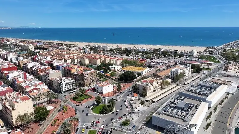 Aerial view of Valencia’s Las Arenas area with beachfront, city blocks, and coastline.