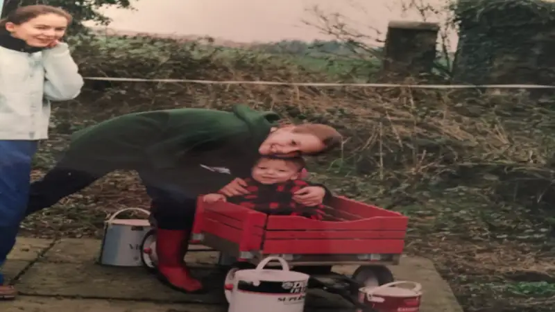 My brother, childhood best friend, and I painting a fence on our property