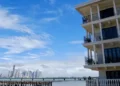A waterfront building with balconies overlooking the ocean