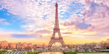 Eiffel Tower at sunset in Paris, France. Romantic travel background