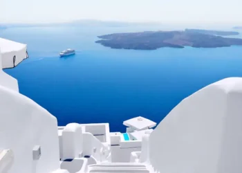 White wash staircases on Santorini Island, Greece. The view toward Caldera sea with cruise ship awaiting.