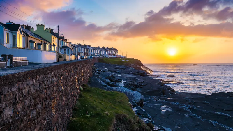 The town of Kilkee in Ireland and a beautiful sunset seen from the shore.