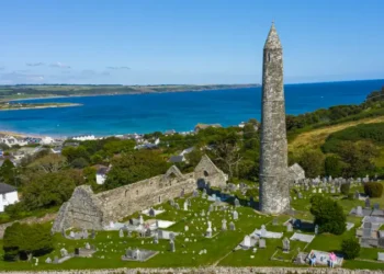 Aerial view of Ardmore Round Tower, Built in the 12h century, the tower stand tall over looking the coastal village of Ardmore.
