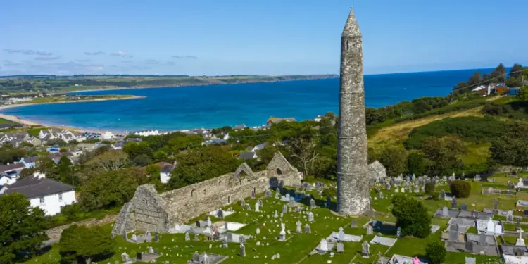 Aerial view of Ardmore Round Tower, Built in the 12h century, the tower stand tall over looking the coastal village of Ardmore.