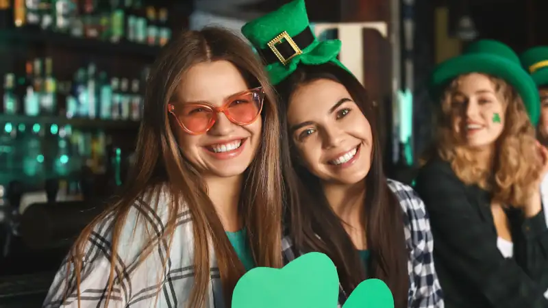 Young women celebrating St. Patrick's Day in pub