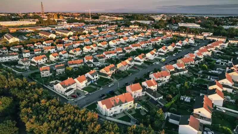 Aerial view on dense residential area with comfortable houses in a city suburb area.