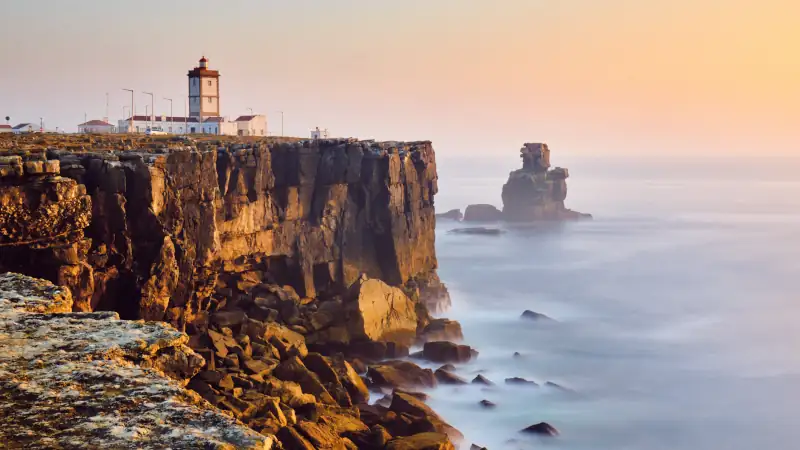 View Of Lighthouse And Sea In Peniche Portugal At Sunset