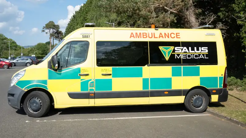 Medical ambulance vehicle, parked, first aid, bright sunny day, no people