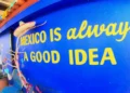 A brightly painted blue wall features the phrase “Mexico is always a good idea” in yellow letters
