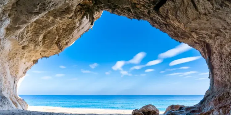 view out of one of the many seaside caves at the beach of Cala Luna in Sardinia