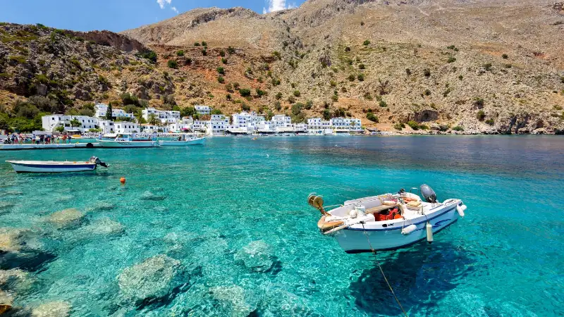 Small motorboat at clear water bay of Loutro town on Crete island, Greece