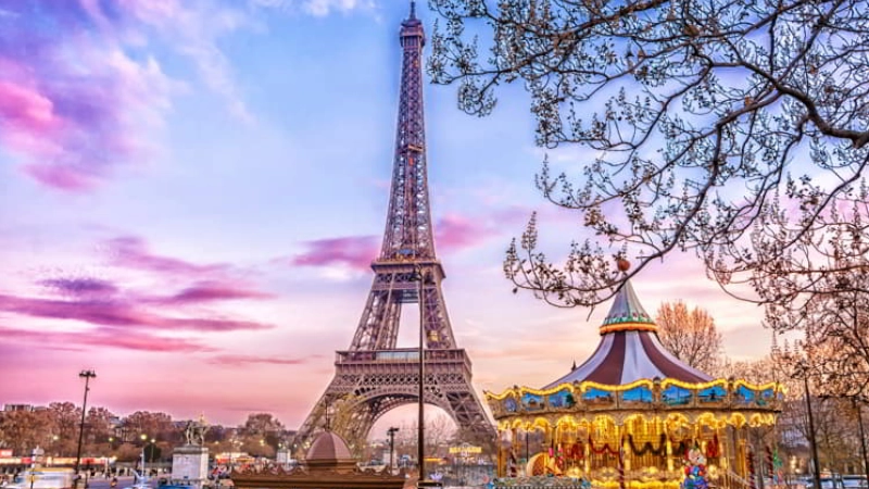 The Eiffel Tower and vintage carousel on a winter evening in Paris, France retire overseas