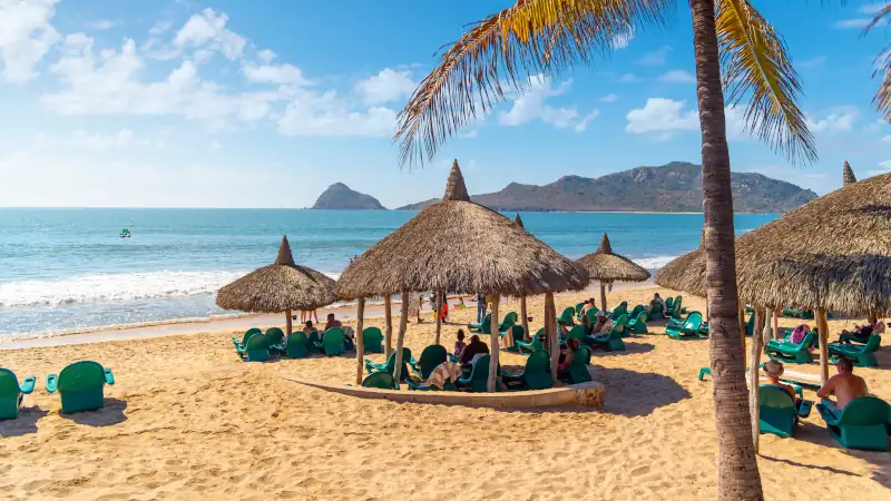 An oceanfront resort offers private huts and cabanas along the sandy Playa Gaviotas beach in the Golden Zone of Mazatlan, Mexico