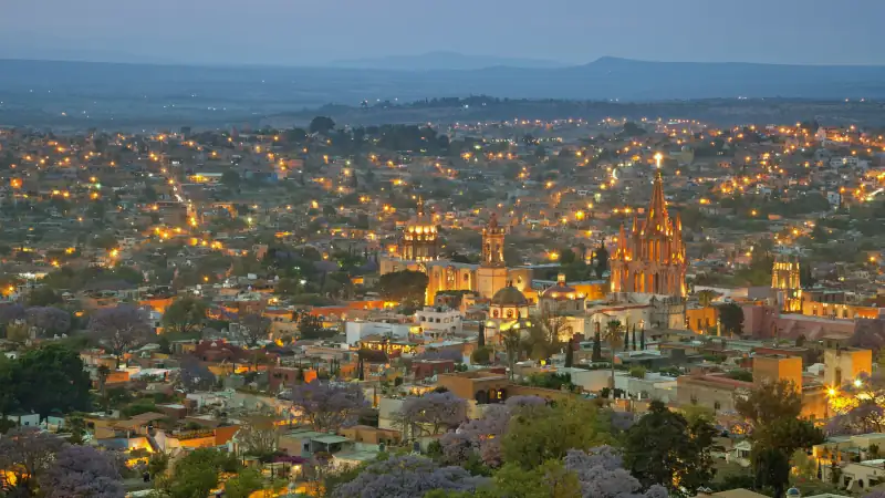 View of San Miguel de Allende after sunset, showing colorful facades