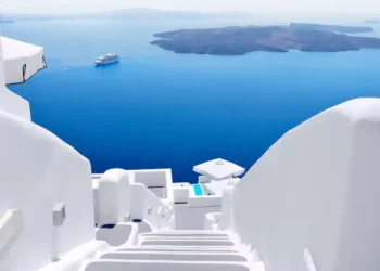 White wash staircases on Santorini Island, Greece. The view toward Caldera sea with cruise ship awaiting.