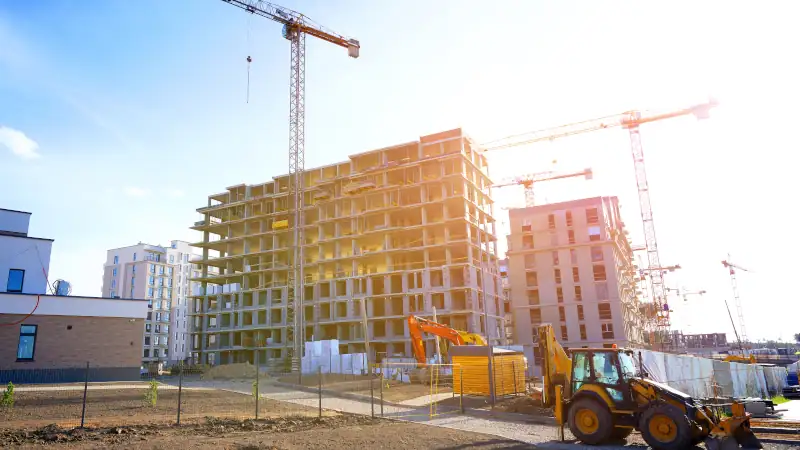 Modern construction site with cranes and machinery, representing skilled trades and development