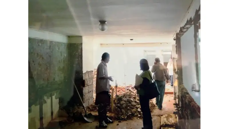 Interior under renovation with exposed walls and construction debris during a home remodel.