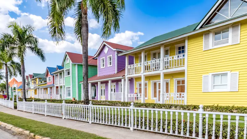 Typical dominican colorful wood houses, palm trees on an emblematic downtown street, Samana, Dominican Republic