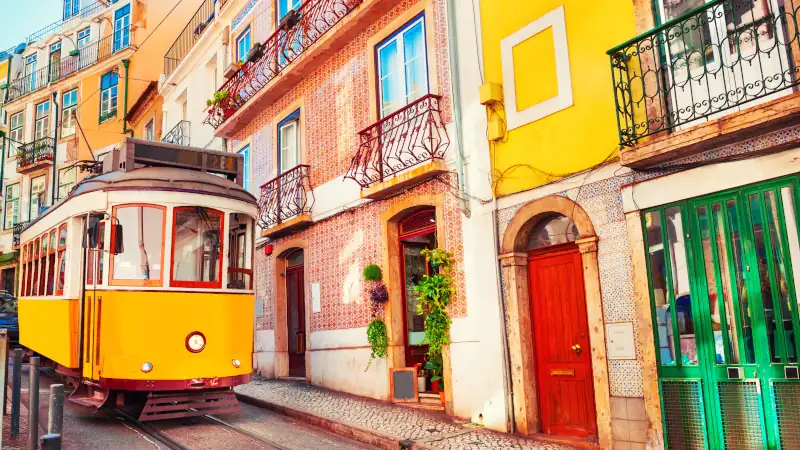 Yellow vintage tram on the street in Lisbon, Portugal.