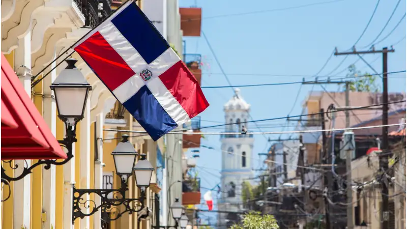 Arzobispo Merino street. Santo domingo. Flag of the Dominican Republic on the wall of a building in the colonial zone