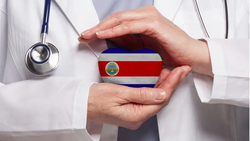 Costa Rican doctor holding heart with flag of Costa Rica background
