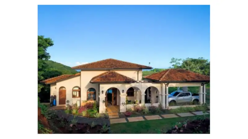 Beautiful Mediterranean-style home in Azuero, featuring terracotta roofs, elegant archways, and landscaped gardens.
