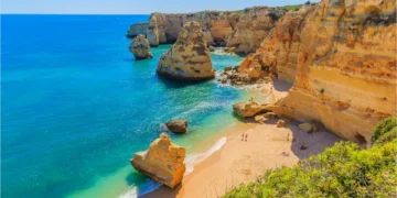 View of beautiful Marinha beach with crystal clear turquoise water near Carvoeiro town, Algarve region, Portugal