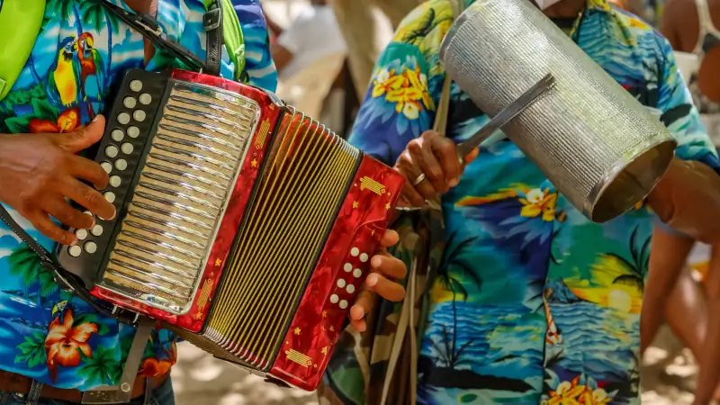 Playing the accordion and guiro